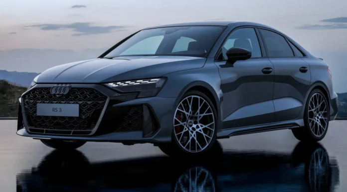2026 Audi RS3 Review: The new America’s Favorite Compact Sedan Front three-quarter view of the refreshed 2026 Audi RS3 luxury performance compact sedan speeding on a track, highlighting its aggressive new stance.