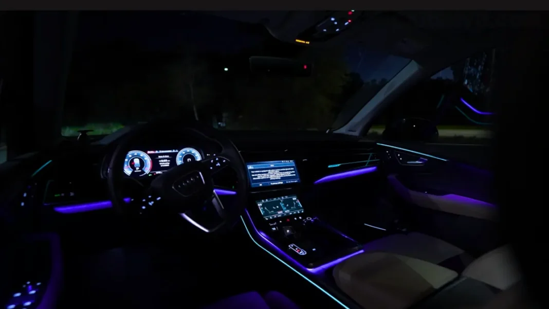 2025-audi-sq7-interior-luxury-cabin-featured Wide-angle premium shot of the 2025 Audi SQ7 luxury interior cabin layout, highlighting the sport steering wheel, ambient lighting, and dual screens.