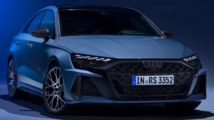 Front three-quarter view of the refreshed 2026 Audi RS3 sport sedan in Ascari Blue, showcasing its wider stance and aggressive new body lines.