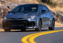 New 2026 Toyota GR Corolla Review: The Rally Car You Can Actually Live With Heavy Metal 2026 Toyota GR Corolla driving on a winding road showing wide fender flares and front grille.